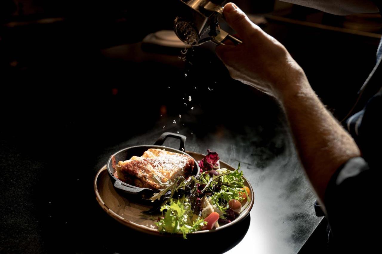 Peppers Waymouth Hotel Adelaide Dış mekan fotoğraf A chef seasoning a dish